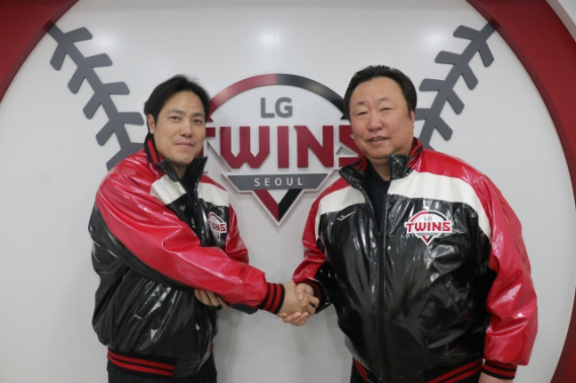 LG's Kim Jin-sung (left) is taking a photo with general manager Cha Myung-seok to commemorate his non-FA multi-year contract. /Photo = Courtesy of LG Twins
