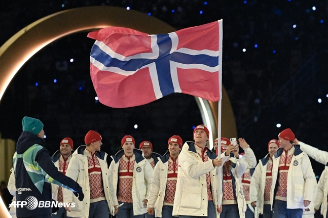图为1月6日（当地时间），在米兰-科尔蒂纳冬奥会开幕式上，挪威选手们正打着国旗入场。 =法新社BBNews=新闻1。
