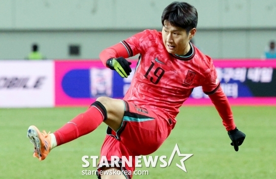 图为李康仁正在尝试左脚踢球。  =照片=金镇京。