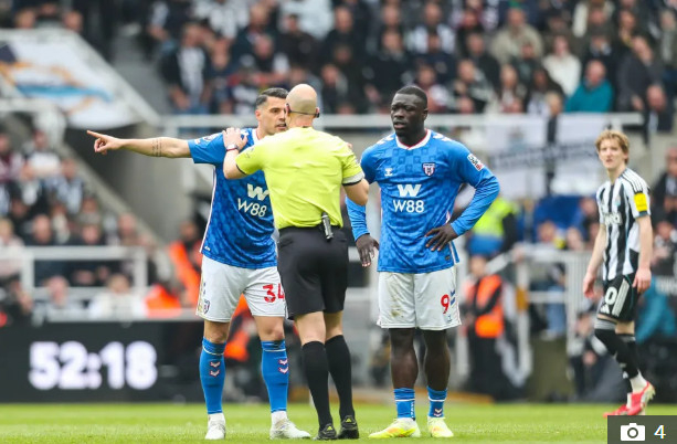 Гранити Зака (слева) и Рут Шарел Гертруда (справа) протестуют против судьи Энтони Тейлора (в центре) в связи с расистских выступлениями в зале. /Фото = Больше солнца в муравейнике