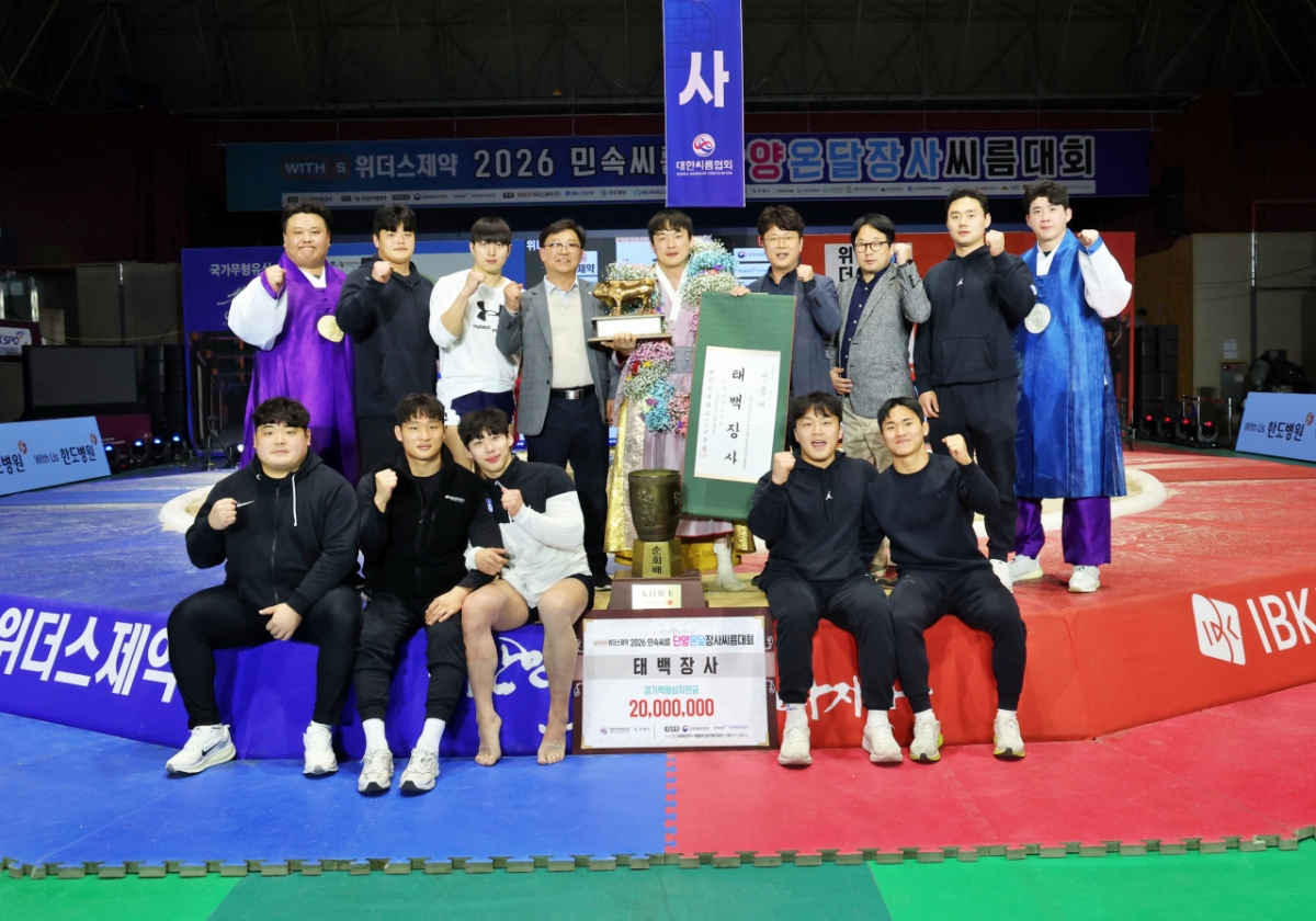 Мун Джун Сок (мэрия Сувона Специального района) делает памятное фото с тренером Ли Чун Ёпом (первый слева от верхней строки), тренером Лим Тэ Хёком (первый справа от верхней строки) и коллегами по команде. /Фото = Предоставлено Корейской ассоциацией реслинга.