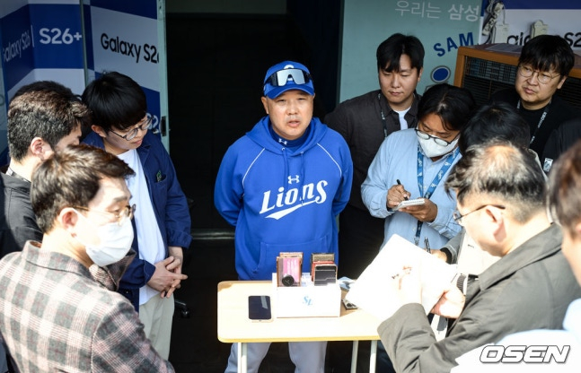 图为，正在接受记者采访的朴镇万教练（中）。