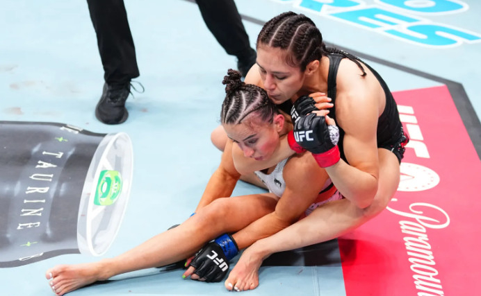 Macy Barber being chocked. /Photo = The Sun Source