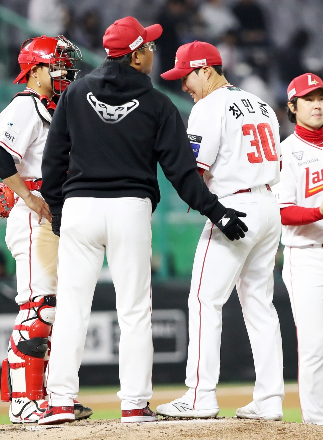 5回表、キョン·ホンホコーチ（左から2番目）がチェ·ミンジュン（左から3番目）が連続四球を許して揺れると、マウンドを訪れて励ましている。 /写真=SSGランダース提供