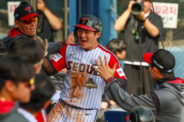 12日，LG双子队的吴志焕（中）在与SSG队的比赛中得分后，正在接受队友们的祝贺。 =照片=LG twins提供。