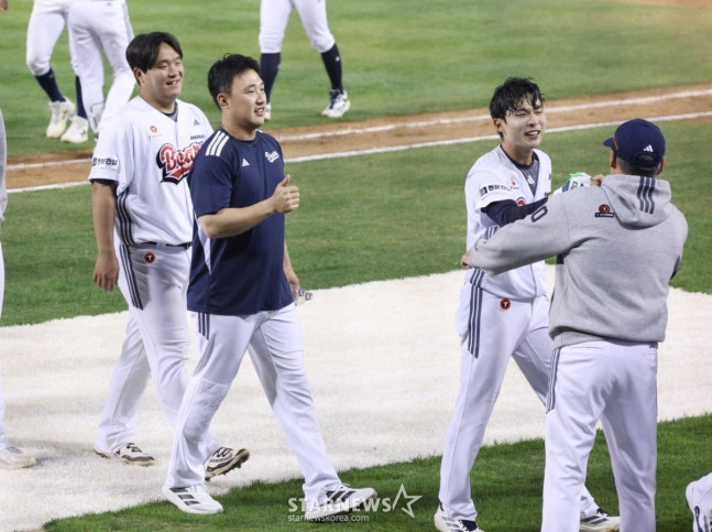 2026新韓（シンハン）SOLKBOリーグの斗山（トゥサン）ベアーズ対KIAタイガースの試合が18日、ソウル蚕室（チャムシル）野球場で行われた。  斗山の李ユチャンが延長10回裏、1死1、2塁でサヨナラ2塁打を放って試合を終えた後、金ウォンヒョン監督の歓迎を受けている。  /写真=キム·ジンギョン待機者