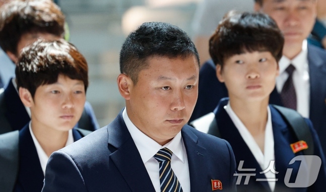 North Korea Hometown Women’s Football Team head coach Ri Yu-il, Kim Kyung-myong, and Kim Hye-young are seen moving toward the exit for departure to Beijing, China, at Incheon International Airport Terminal 1 on the afternoon of the 24th. /Photo=NEWS1