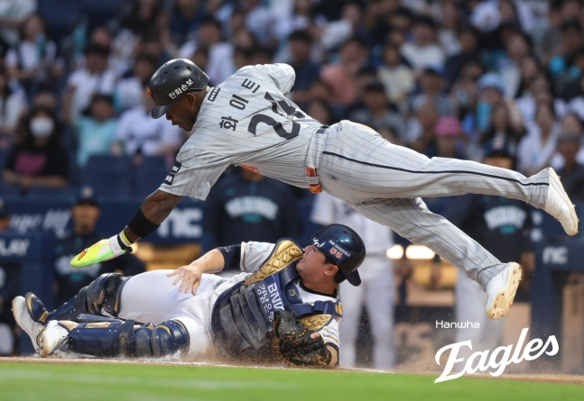 Hanwha Eagles' Yonatan Peraza (top) evades NC catcher Kim Hyung-jun's tag with a delicate maneuver to score during a match against the Changwon NC Dinos on the 26th of last month. /Photo=Hanwha Eagles