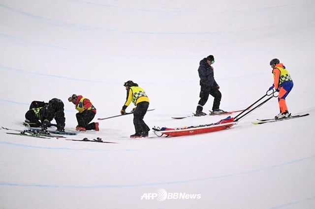 최가온(가장 왼쪽)이 지난 13일(현지시간) 이탈리아 리비뇨 스노파크에서 열린 2026 밀라노·코르티나담페초 동계올림픽 스노보드 여자 하프파이프 결선에서 1차 시기에서 넘어진 뒤 의료진과 들것이 투입되고 있다. /AFPBBNews=뉴스1