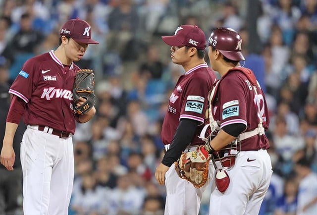 During the game on the 6th, Bae Dong-hyun (left) and pitching coach Noh Byung-oh (center) are seen having a conversation. /Photo=Kiwoom Heroes