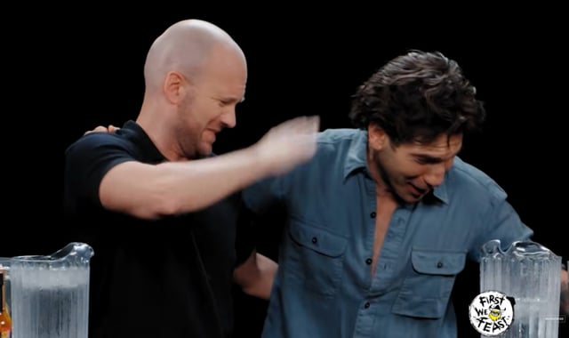 The moment Tom Holland (off-screen) bows his head and vomits. Photo: Screenshot from YouTube 'Hot Ones' video