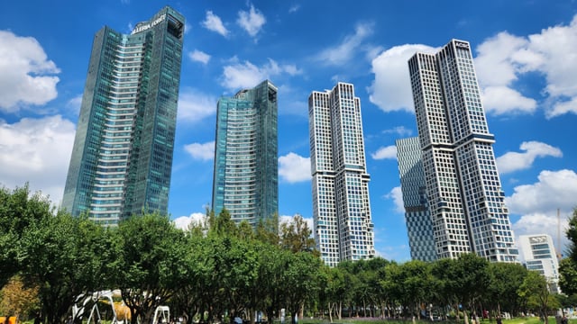 High-rise apartments near Seoul Forest. The scene reflects a harmony between urban life and nature.