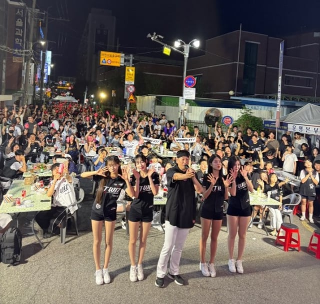 KTウィズ応援団が4日、水原市長安区松竹洞路地一帯で開かれた「ウィズファミリーin松竹洞野場」行事で商人会住民たちと共にKTを応援した。 /写真=KTウィズ提供