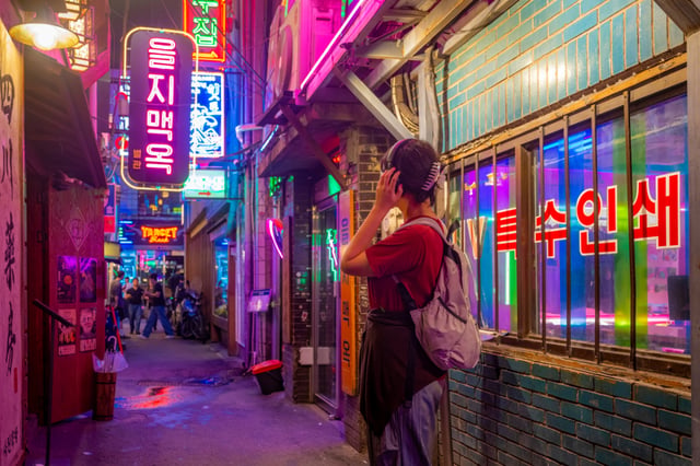 A vibrant space where neon photos and print shop signs blend together on Euljiro.