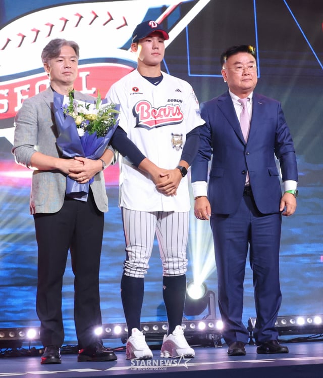서울고 김지우(가운데)가 21일 서울 송파구 롯데호텔 월드 크리스탈볼룸에서 열린 '2027 KBO 신인 드래프트'에서 전체 2순위로 두산 베어스의 지명을 받고 김태룡 단장(오른쪽), 아버지와 기념촬영을 하고 있다. /사진=김진경 대기자