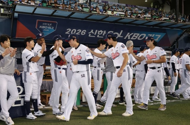 2026愛知·名古屋アジア大会で金メダルを取って帰ってきた選手たちが29日、NCダイノスとのホーム試合を控えて祝賀行事を終えた後、同僚たちとハイタッチをしている。 /写真=斗山ベアーズ提供