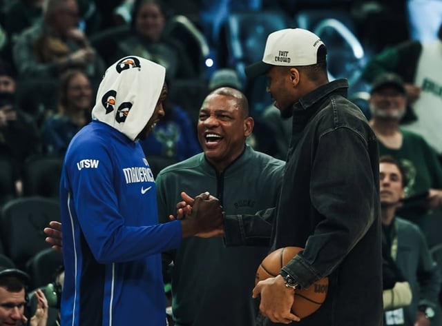 Doc Rivers (center) awkwardly inserting himself into a conversation involving Giannis Antetokounmpo (right). /Photo=Official Milwaukee Bucks SNS